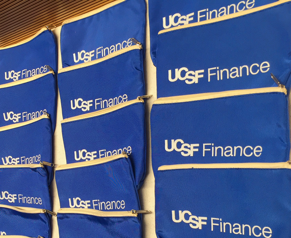 Blue bags with white writing that says UCSF Finance.